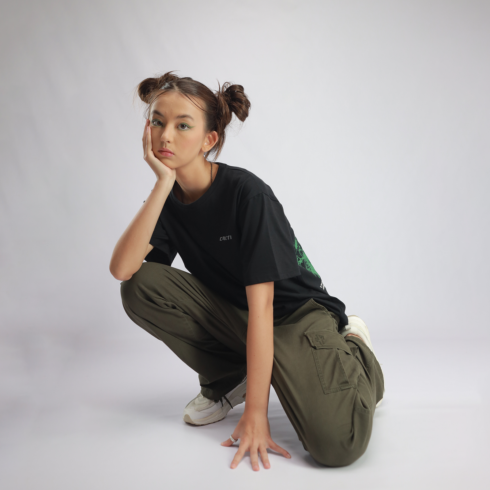 Model crouching in CACTI streetwear